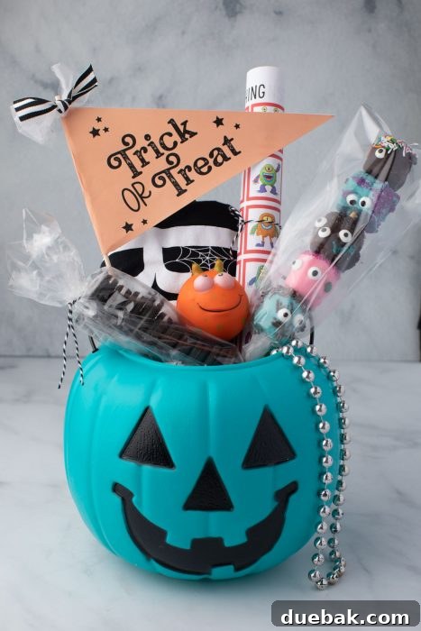 Pumpkin bucket filled with treats, games, and decorations