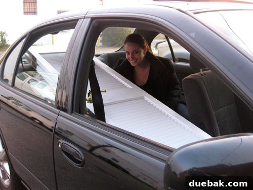 5 Genius Ways to Move Big Stuff Your Car Can't Carry 5 Sherry sitting in backseat of a car with doors through passenger seat