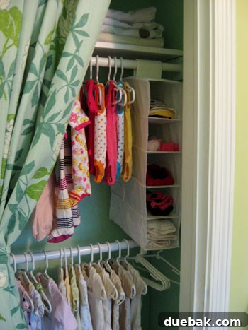 Top shelf of nursery closet with storage box and folded blankets