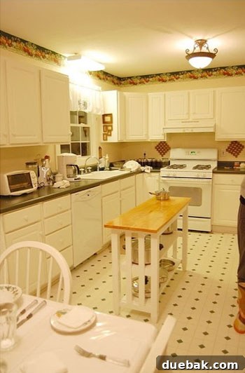 Outdated kitchen with dark cabinets and traditional decor before renovation.