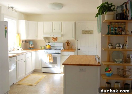 Bright and airy kitchen after renovation with white cabinets, light countertops, and a charming eating nook.