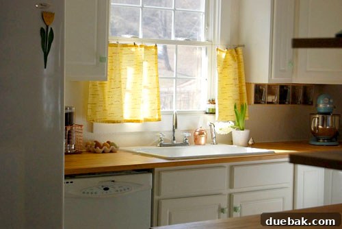 Kitchen view showing a vibrant turquoise vintage-style stove as a focal point.