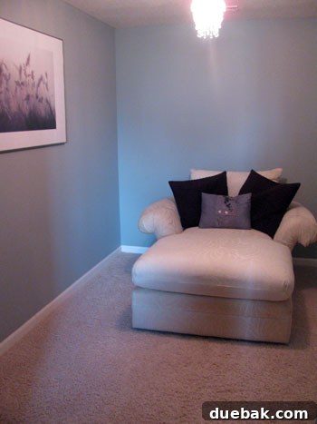 Affordable Home Office Transformation 2 Before image of an unused sitting nook, cluttered with laundry items, showing its underutilized potential.