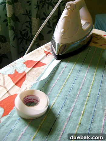 Applying iron-on hem tape to fabric edge