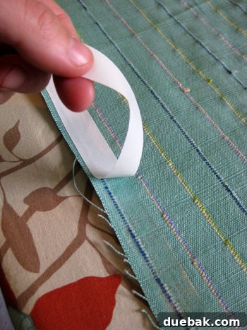 Peeling backing from hem tape