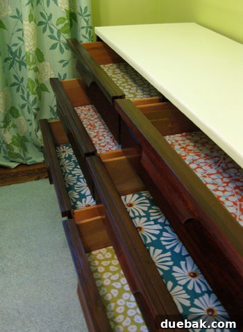 A dresser drawer lined with a vibrant patterned paper, revealing a fun and unexpected pop of color and design.