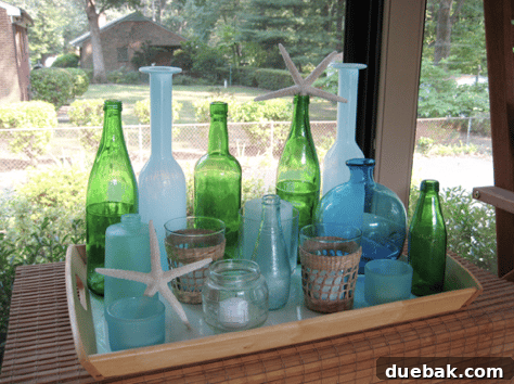 A collection of decorative bottles and vases in various shapes and colors arranged on a tray, creating an artistic display.