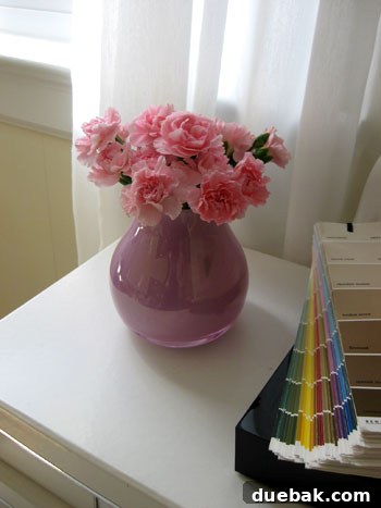 A beautiful bouquet of soft pink and white flowers in a vase, creating an elegant and delicate spring floral arrangement.