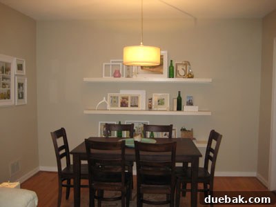 Dining area with CB2 pendant light, viewed from the living room, showing the seamless integration into an open-plan space.