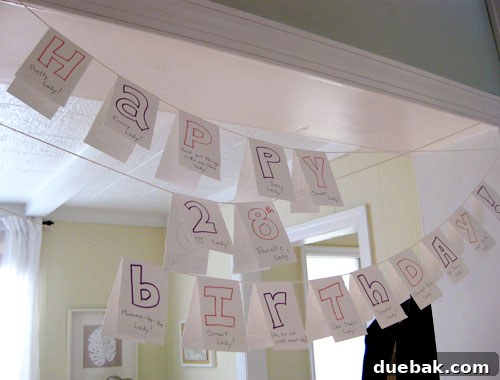 Birthday Bonanza: Smartly Sourced Splendor 5 Homemade birthday banner with colorful letters and small hearts, strung across a doorway, featuring personal love notes.