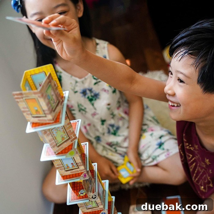 Fun Board Games for Six-Year-Olds 14 A child's hands carefully stacking colorful game components, demonstrating dexterity and concentration.