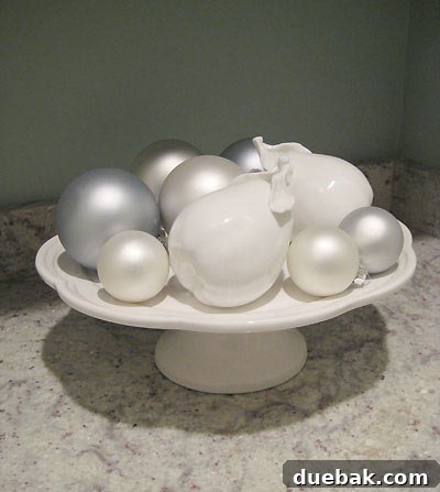 Chic cake stand showcasing a collection of decorative ceramic fruits