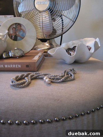 Smaller faux shell used as an elegant holder for jewelry on a vanity
