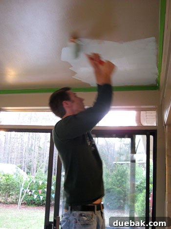 Seamless Corner Curtain Rod Installation 4 John meticulously painting the sunroom ceiling with a roller, ensuring clean lines