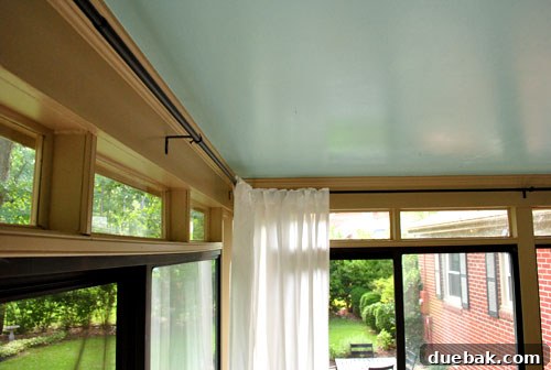 Seamless Corner Curtain Rod Installation 6 Sunroom with newly installed sleek dark curtain rods and flowing white IKEA curtains