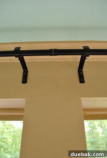 Seamless Corner Curtain Rod Installation 7 Close-up of two dark IKEA curtain rods expertly joined in the middle of the wall