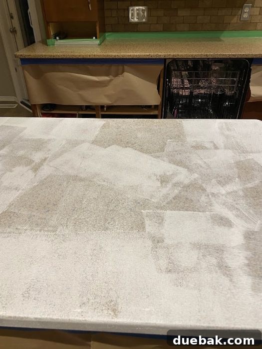 Revamp Your Granite Countertops with Paint 12 Second coat of primer drying on the kitchen counter.