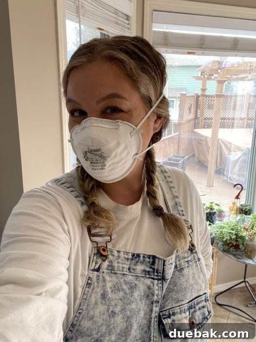 Revamp Your Granite Countertops with Paint 17 Person sanding the countertop with a rotary sander connected to a shop vac.