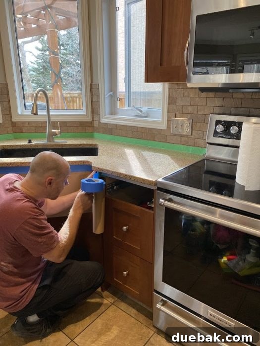 Revamp Your Granite Countertops with Paint 9 Kitchen countertop fully prepped with tape and plastic sheeting.