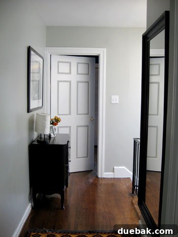 Step Inside This Exquisite City Residence 8 Second-floor hallway with striking two-tone doors and a hallway chest.
