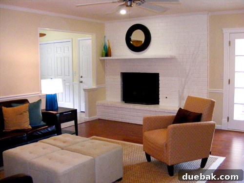 Ashley's renovated living room with new flooring and cream walls.