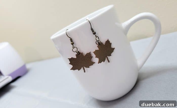 Faux leather earrings shaped like maple leaves in various fall colors.