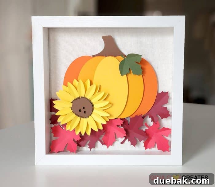 Intricate layered cardstock pumpkin shadow box in autumnal colors.