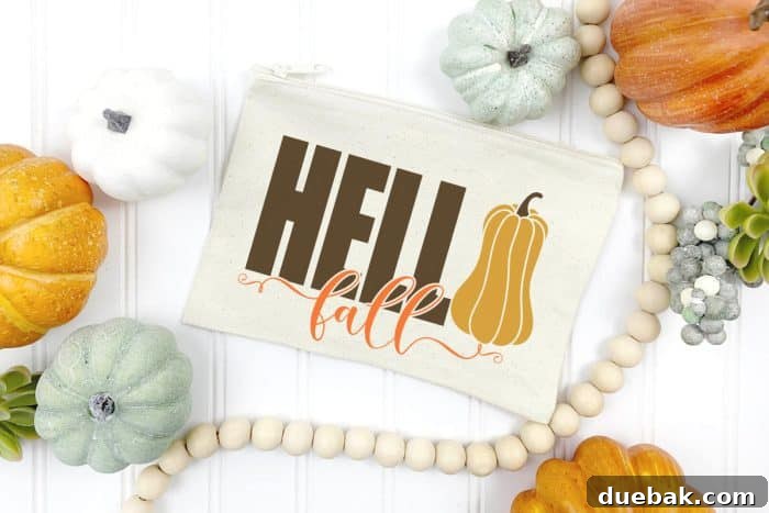 Cosmetic bag adorned with 'Hello Fall' text and a gourd illustration.