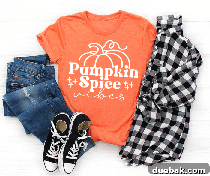 Orange shirt displaying 'Pumpkin Spice Vibes' in a stylish font.
