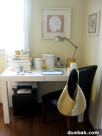 Home office desk styled with chic metallic accents, featuring capiz boxes, gold cubes, and scented elements.