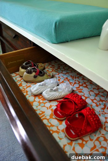 Emerald and Aqua Dreams for Our Girl 13 Opened dresser drawer revealing lined interior and tiny baby shoes