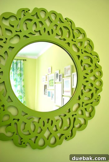 Emerald and Aqua Dreams for Our Girl 20 Repurposed mirror with a green frame, reflecting light in the nursery