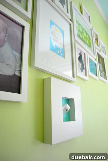 Emerald and Aqua Dreams for Our Girl 23 Close-up of a framed placeholder for baby's hospital wristband on the art wall
