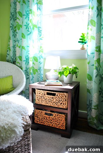Emerald and Aqua Dreams for Our Girl 7 Side table with woven baskets acting as drawers, next to a cozy reading chair