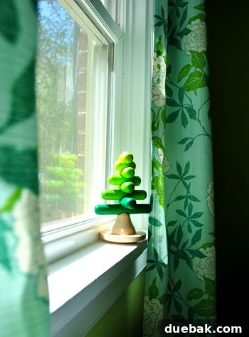 Emerald and Aqua Dreams for Our Girl 9 Close-up of the windowsill with a small wooden tree toy, showcasing natural light