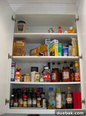 Together We Tame Kitchen Cabinets 3 Another 'before' photo revealing a messy kitchen cabinet filled with snacks, containers, and baking supplies