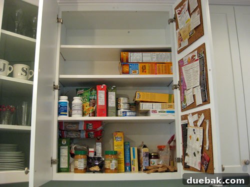 Before: Overstuffed kitchen cabinet with disorganized food items