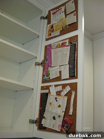 Cleaned up in-cabinet cork board with recipes and articles