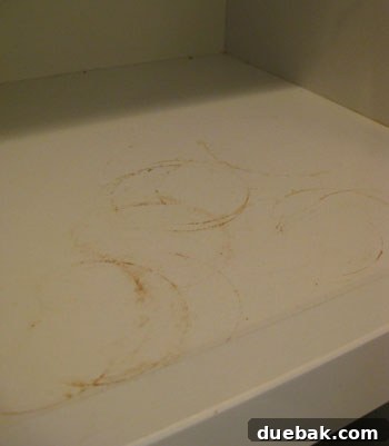 Stained cabinet shelf from cooking oils and sprays