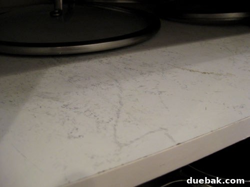 Scrape marks on cabinet shelf from pots and pans