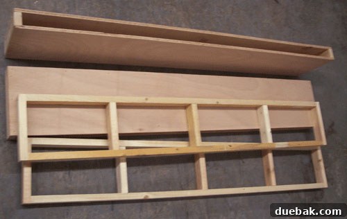 Photo displaying two completed internal wood frame pieces and two outer shelf boxes ready for the DIY floating shelf project