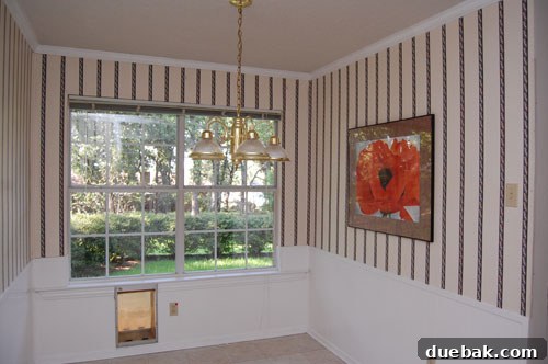 Transform Your Kitchen Without Breaking the Bank 4 View of the solid wall separating the kitchen and dining room, contributing to a dark and enclosed atmosphere prior to the major renovation.