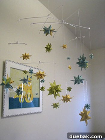 Close-up of a handmade Moravian Star mobile showing delicate paper patterns and construction details.