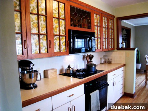Grasscloth & Paint: A Fresh Take on Cabinet Updates 2 Before kitchen photo showing dated brown cabinets and an uninspired interior design.