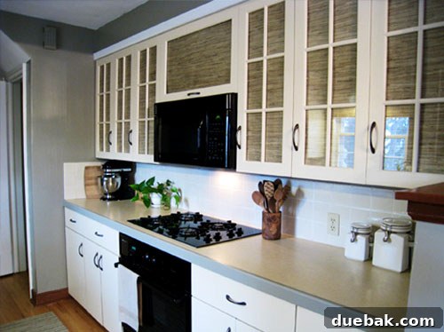 Grasscloth & Paint: A Fresh Take on Cabinet Updates 5 Close-up after photo showing the transformed kitchen with elegant cabinet hardware and a fresh color palette.