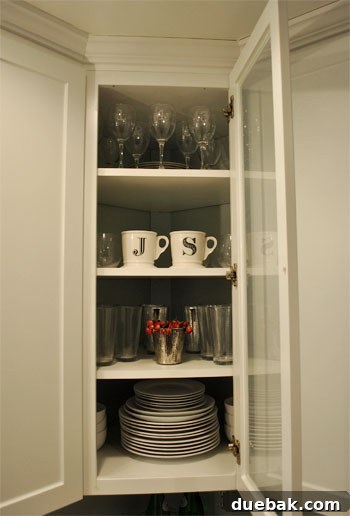 Another before photo showing dishes and glasses in the cabinet