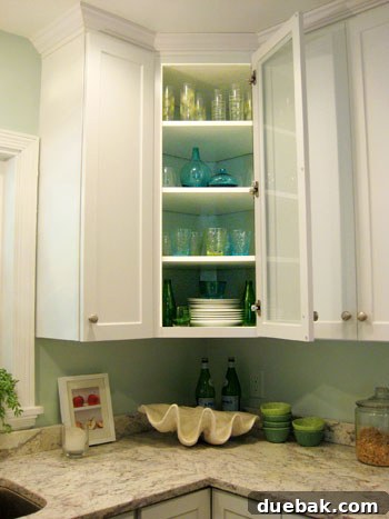 After photo of the refreshed glass-front cabinet with new colorful glassware
