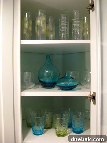 Mid-level shelf with blue Ikea vases replacing mugs