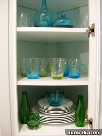 Bottom shelf with repurposed items and white bowls