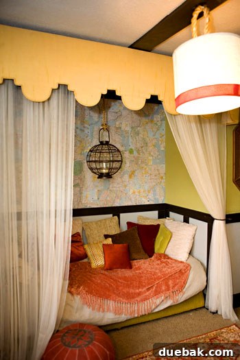 Close-up of the reading nook with a map on the wall and a comfortable padded pouf, reflecting a worldly theme.